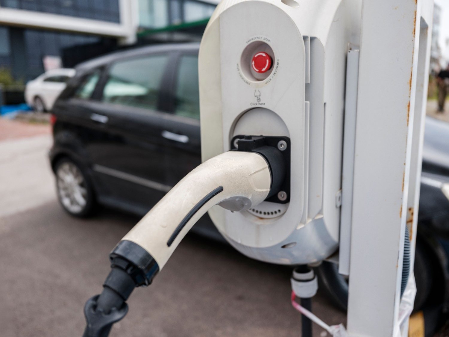 EV charging connector plugged into a commercial charging station