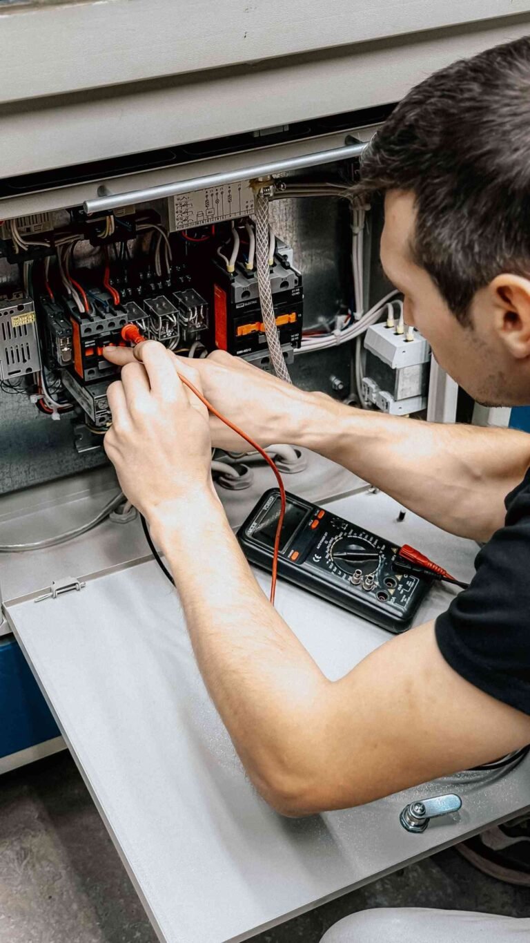Electrician testing electrical panel wiring in West Palm Beach, FL