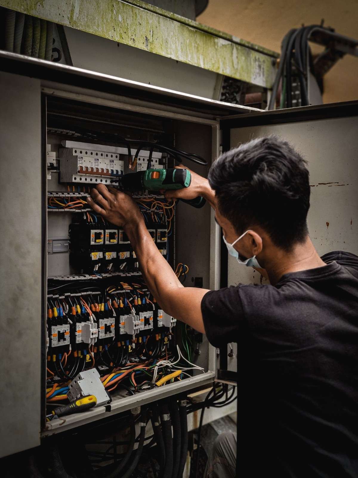 Electrician working on an electrical transfer switch panel