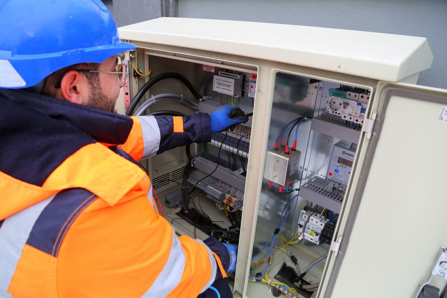 Electrician installing an automatic transfer switch control panel
