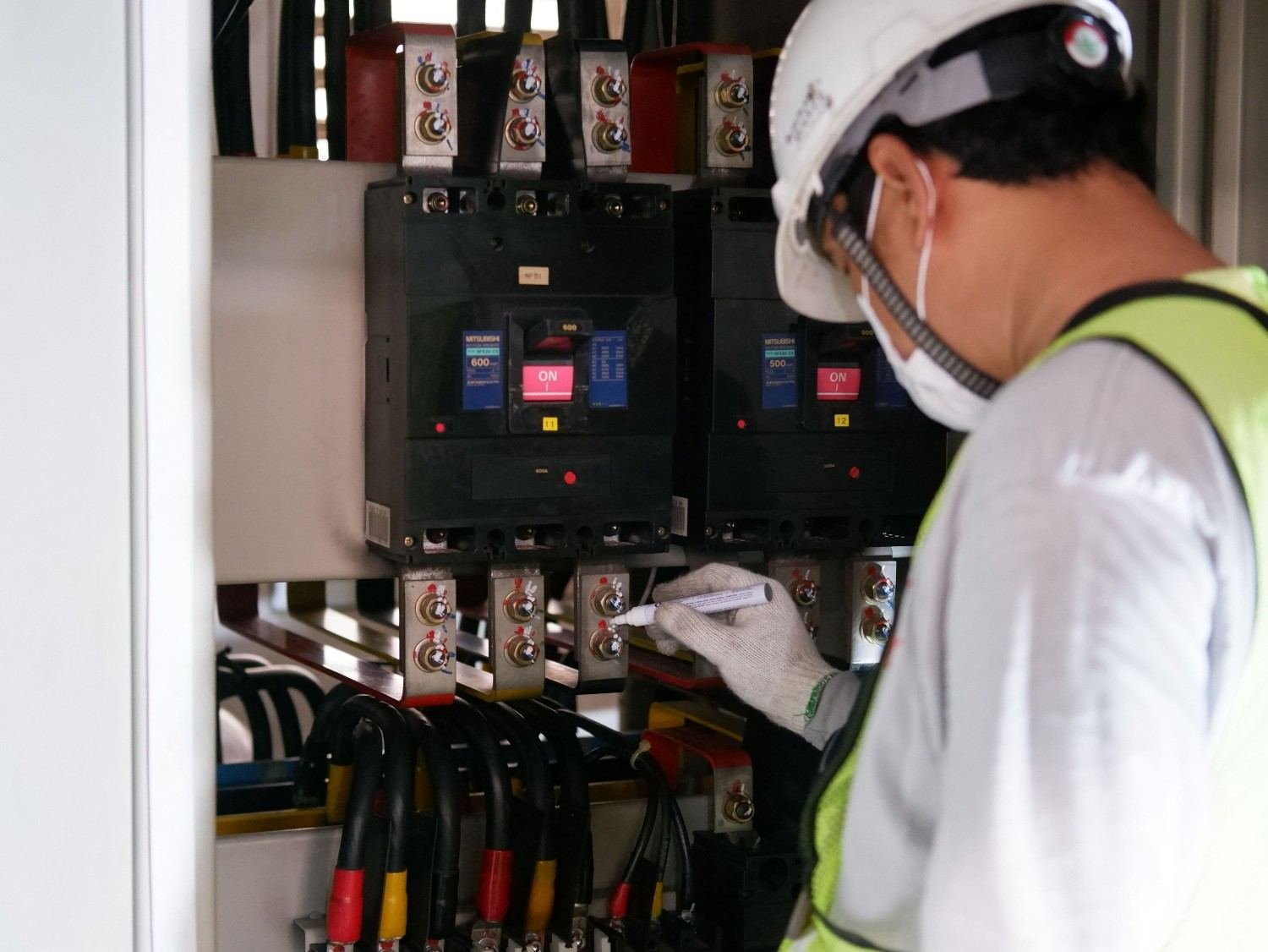 Electrician inspecting an automatic transfer switch panel