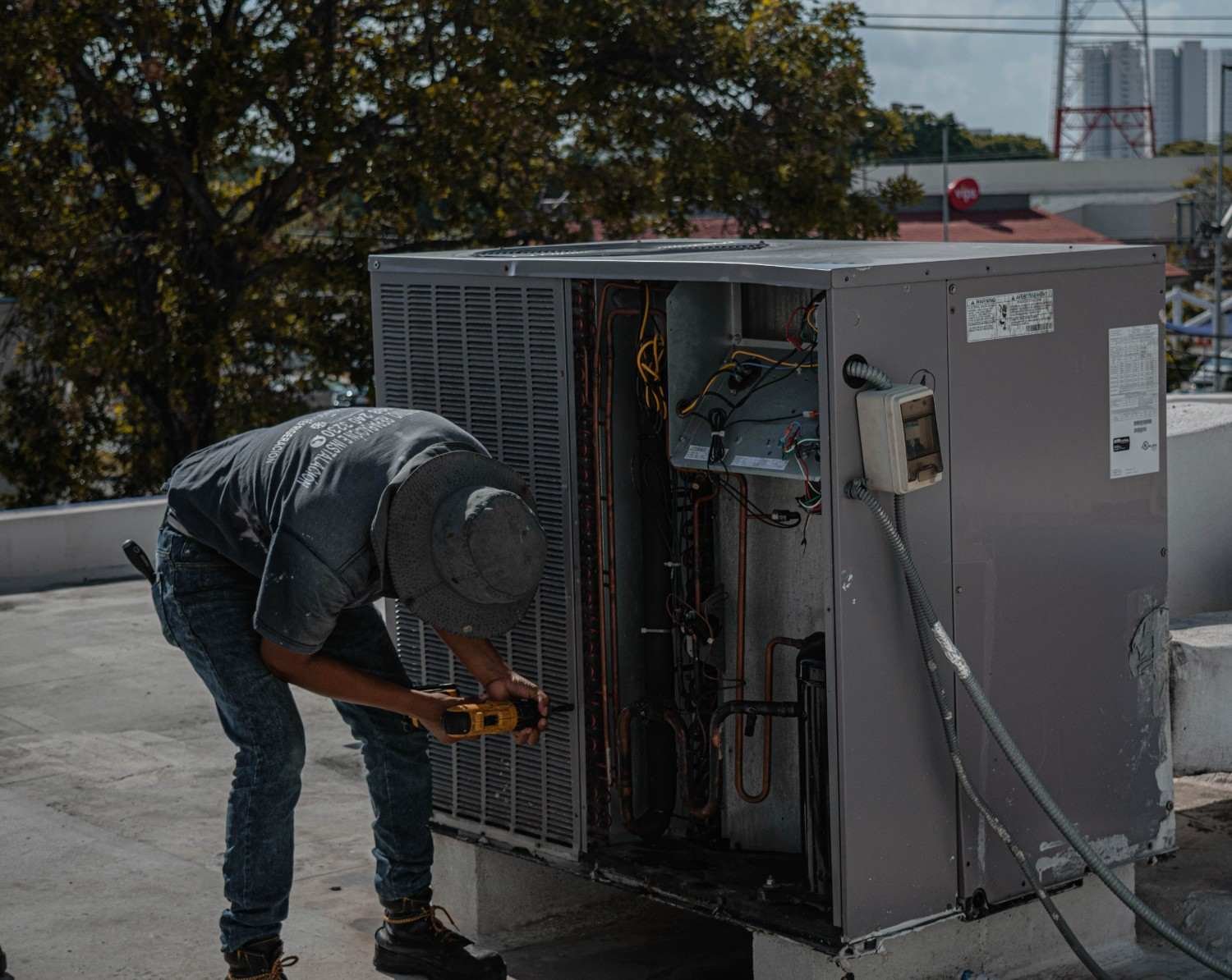 Technician inspecting and repairing electrical equipment for generator maintenance