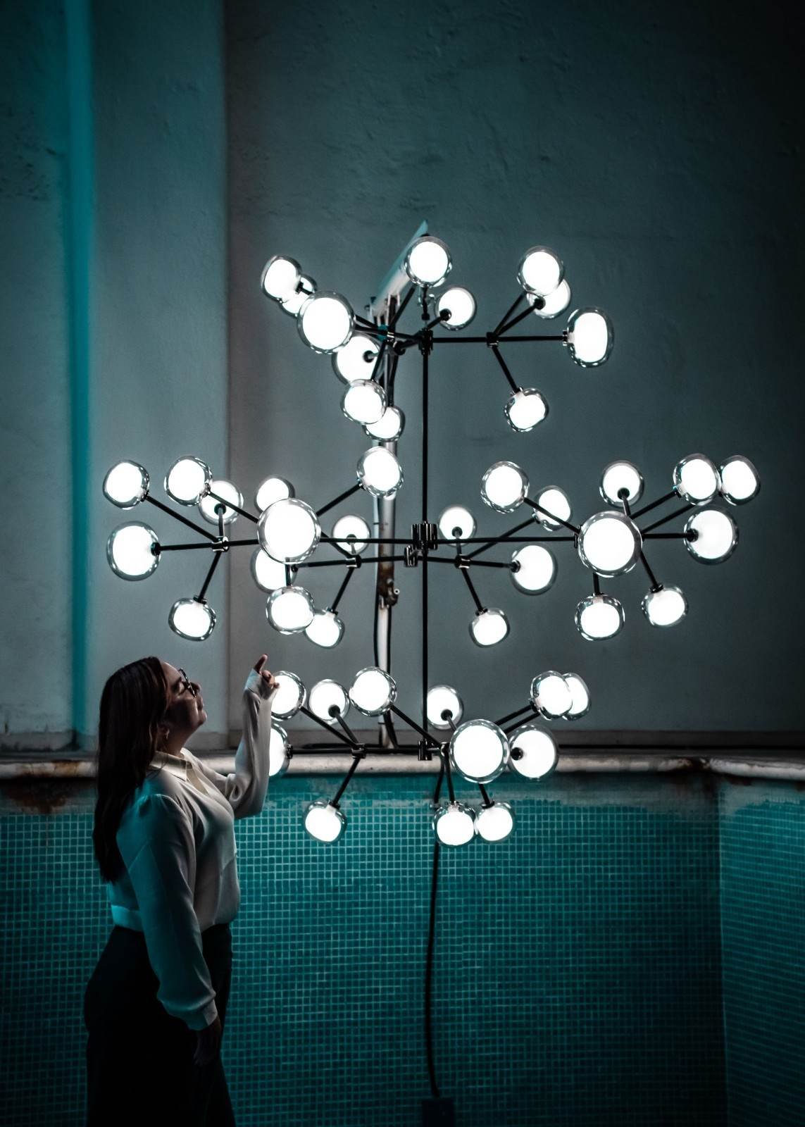 Modern multi-light chandelier installation for custom lighting design in West Palm Beach, FL